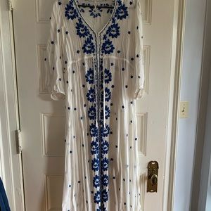 Free People white dress with blue embroidery.